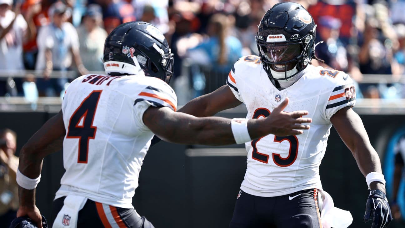 D'Andre Swift and Kyle Monangai celebrate after a touchdown.